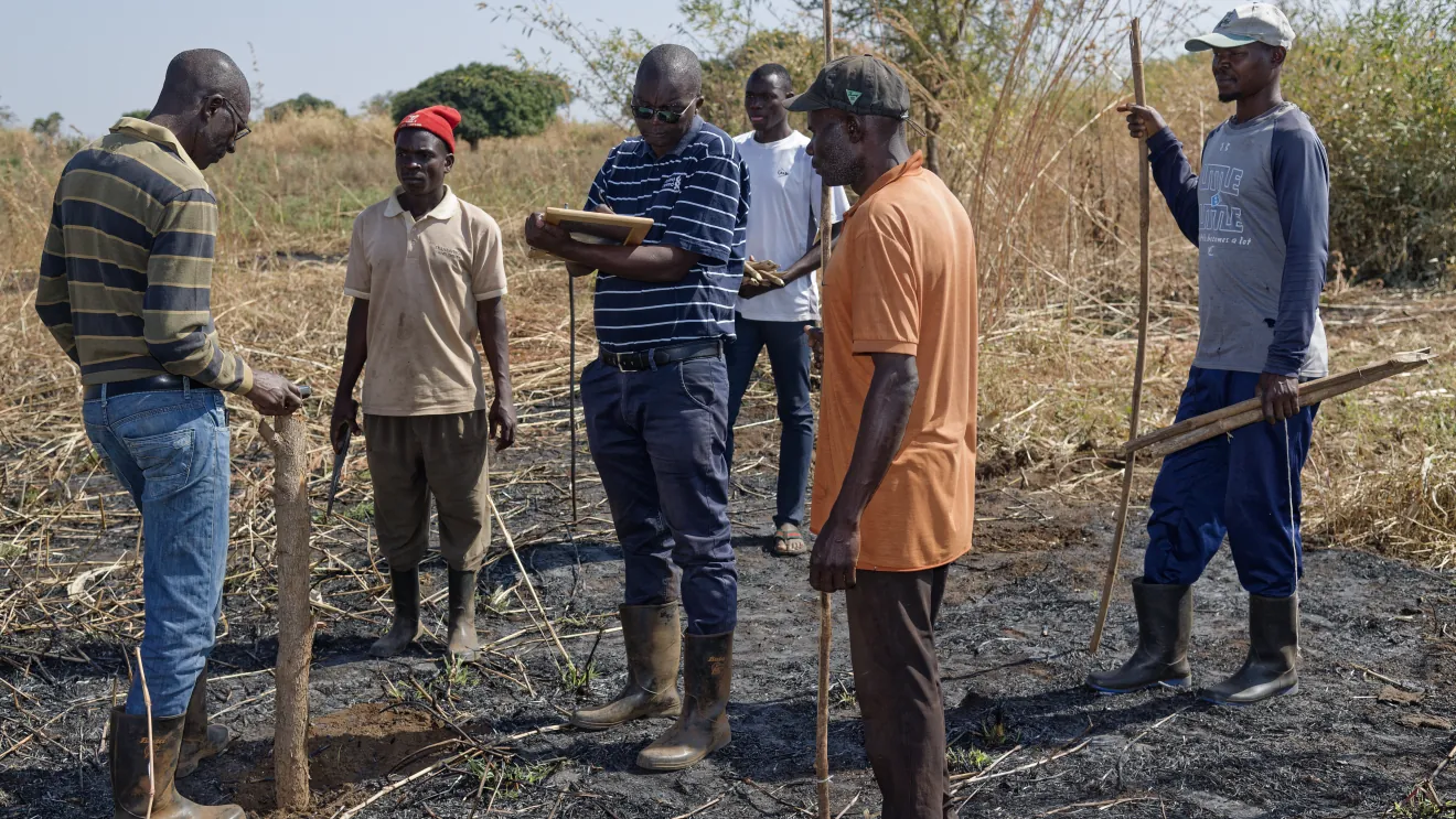 Team recording coordinates in the field
