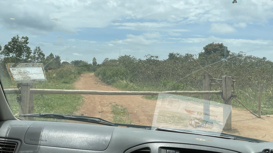 Photo through the windscreen: Road with closed cabinet. Uganda - Democratic Republic of Congo border.