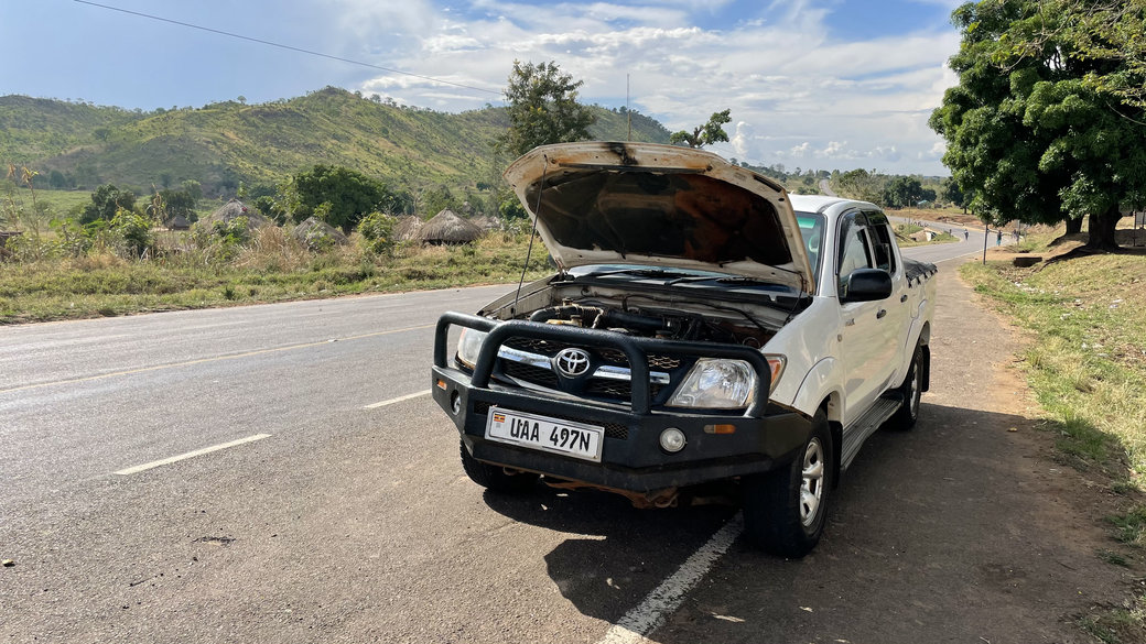 Toyota Hilux with open bonnet at the roadside
