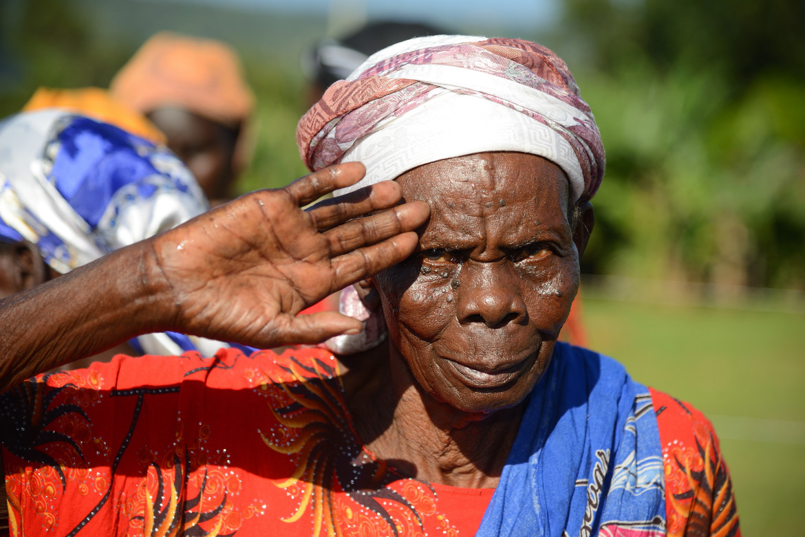 Kenyan woman greets with raised hand