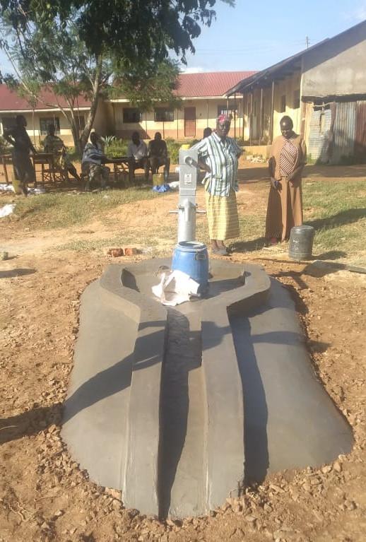 Completely installed hand pump with concrete drain