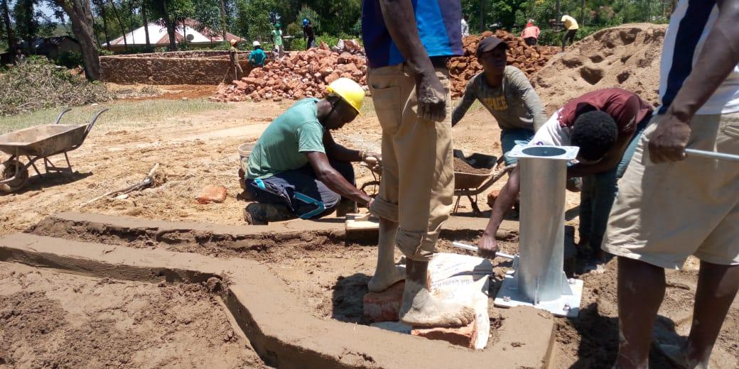 Workers casing the borehole